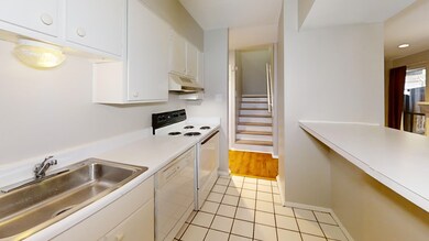 Kitchen featuring white dishwasher, electric range