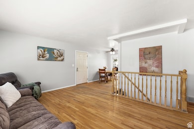 Living area with wood finished floors and ceiling fan