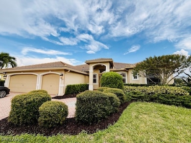 Mediterranean / spanish-style house featuring a garage, stucco siding, decorative driveway, a tiled roof, and a front lawn