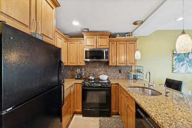 Kitchen with black appliances, tasteful backsplash, light stone counters, light tile patterned floors, and hanging light fixtures