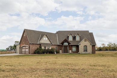 View of front facade featuring fence, driveway, a 