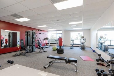 Workout area featuring carpet floors and a paneled ceiling