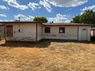 Back of house featuring a lawn