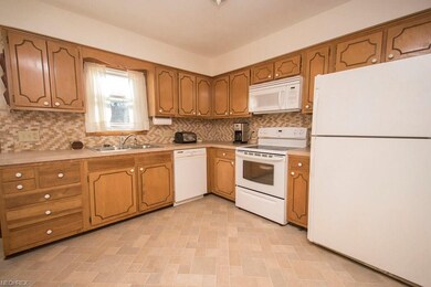 Kitchen with new vinyl floors, new back-splash, an