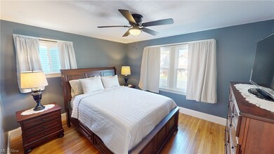 Master Bedroom with multiple windows, light wood-type flooring, and ceiling fan