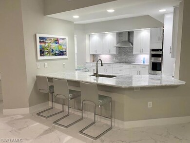 Kitchen with white cabinets, sink, kitchen peninsu