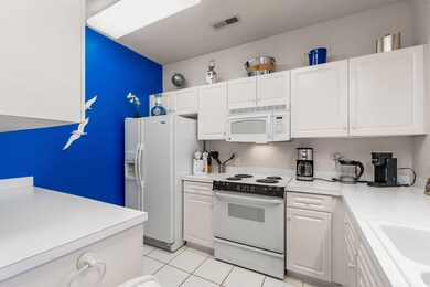 Kitchen with visible vents, light countertops, whi