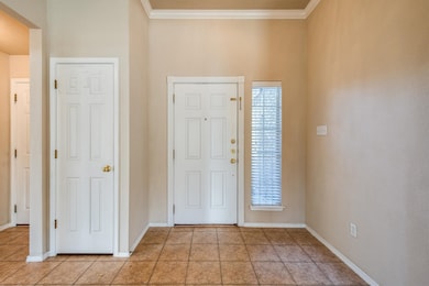 Tiled foyer with ornamental molding