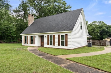 Cape cod house featuring a shingled roof and a chimney