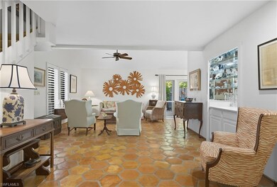 Living area with baseboards and a ceiling fan