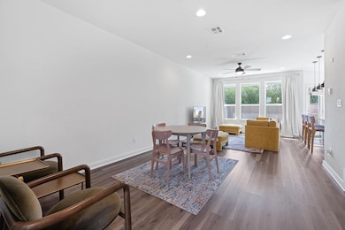 Dining area with ceiling fan, dark wood-type floo