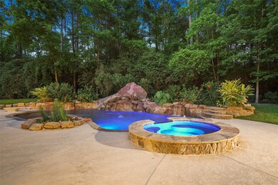 Sparkling pool and spa with slide, diving board and waterfalls night shot photo