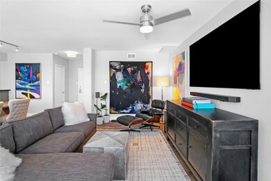 Living area featuring a ceiling fan, wood finished floors, and track lighting