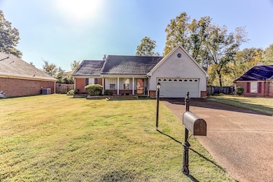 Single story home with cooling unit, a garage, and