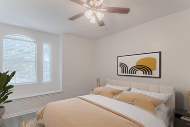 Bedroom with wood finished floors and a ceiling f