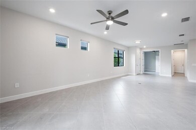 Spare room with a ceiling fan, recessed lighting, light tile patterned flooring, and baseboards