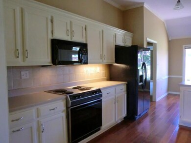 This spacious kitchen has custom style cabinets an