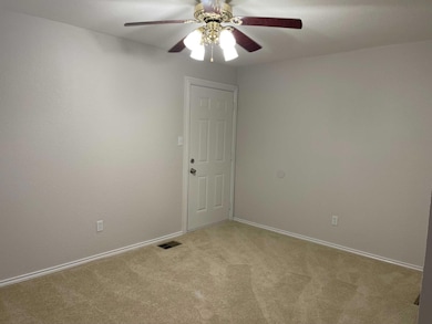 Spare room featuring carpet flooring, baseboards, 