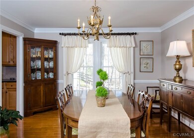 The dining room has hardwood floors, crown and cha