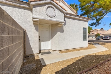 Property entrance with a tiled roof and stucco siding