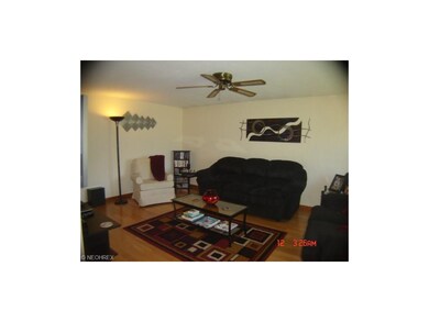 Living room has beautiful hardwood floors, and ple