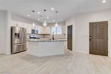 Kitchen with stainless steel appliances, white cab
