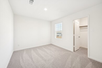 Unfurnished bedroom featuring a walk in closet, light carpet, and recessed lighting