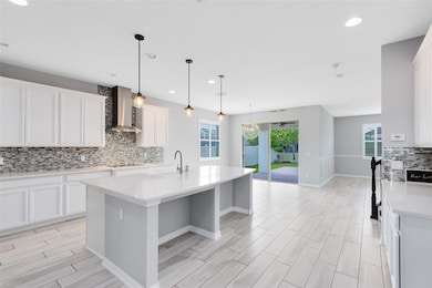 Upscale tile backsplash, high end cabinets, countertops and lighting.
