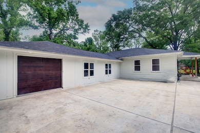 Expansive concrete driveway pad offers ample space