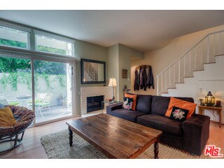 Living room, fireplace, and front patio