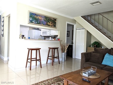 Living room featuring light tile patterned floors,