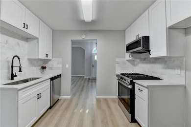 Kitchen featuring light wood finished floors, stai