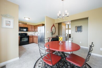 The open dining room and kitchen are a cheerful place to enjoy meals!