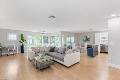 Living room featuring ceiling fan, light hardwood / wood-style flooring, and a healthy amount of sunlight