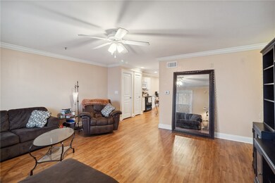 Living area featuring wood finished floors, visibl
