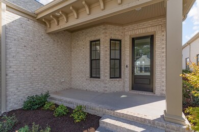 Doorway to property with a patio area