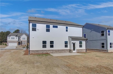 Back of property featuring a patio area and oversi