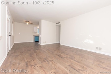 Unfurnished living room with dark wood-style flooring and a ceiling fan