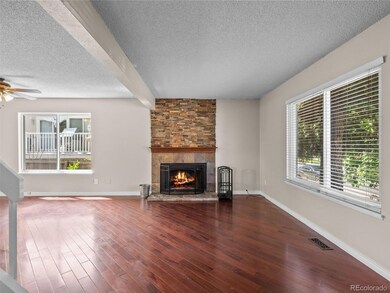 Mahogany wood floors, wood burning fireplace surro