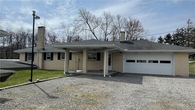 View of front of home featuring a garage and a front lawn
