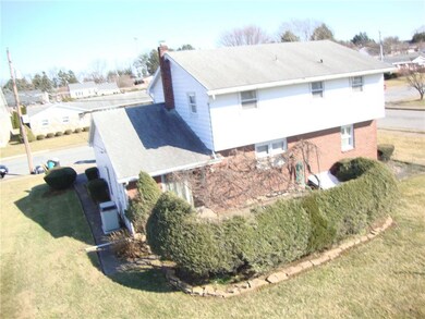 Elevated view of back showing manicured shrubs and