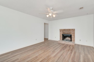 Unfurnished living room with a ceiling fan, light