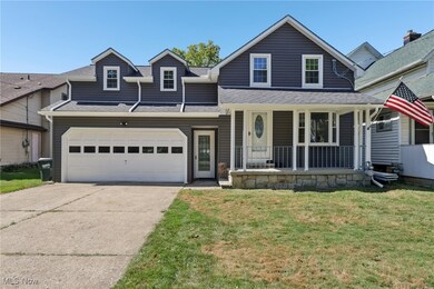 View of front facade featuring covered porch, roof with shingles, a front lawn, concrete driveway, and a garage
