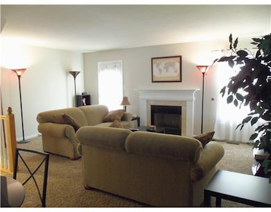 Living Room. Gas Fireplace with French Door to Dec
