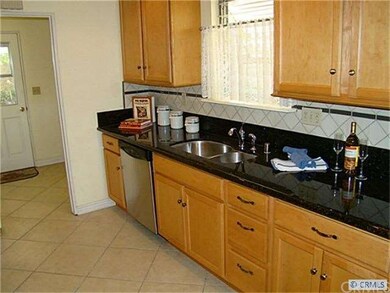 Kitchen with granite counters, tiled backsplash, t