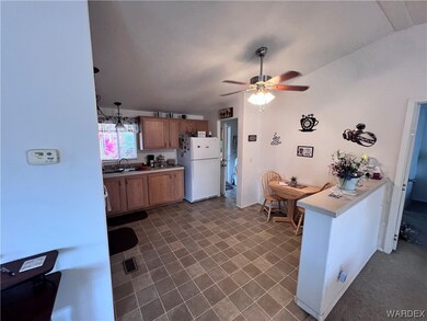Kitchen featuring sink, lofted ceiling, dark tile