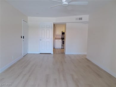 Unfurnished room with a ceiling fan and light wood