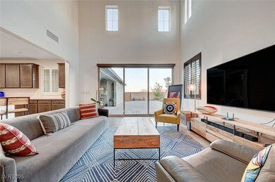 Living room featuring a high ceiling and wood fini