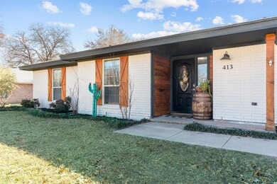 View of exterior entry featuring a yard