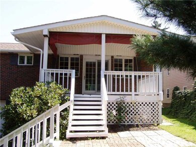 Exterior Back. Covered back patio/porch leads to p